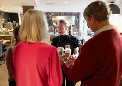 couple at cafe talking to barista