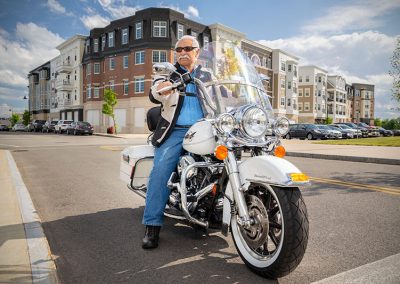 older man in blue on motorcyle