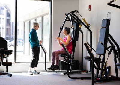 couple in gym on equipment