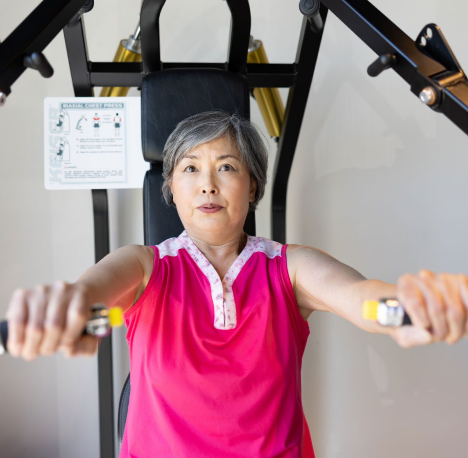 lady in pink shirt on work out machine