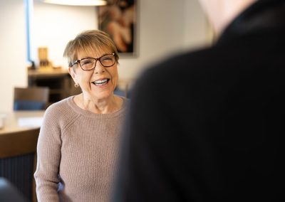 woman in glasses smiling at man