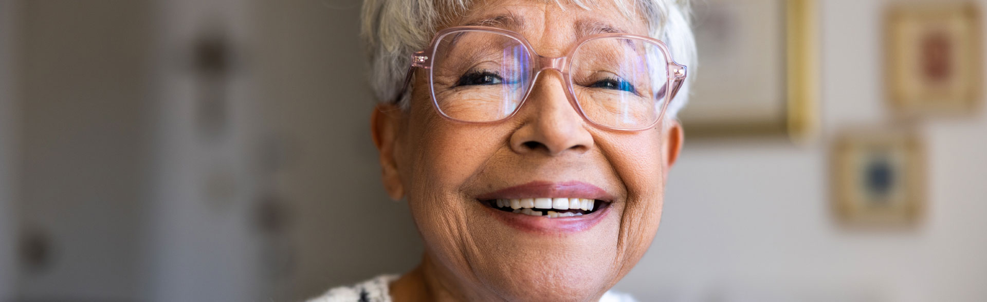 header gray haired woman in glasses smiling