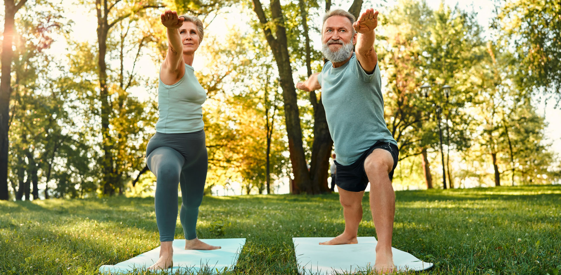 couple doing yoga in park