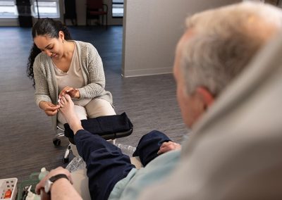 lady giving pedicure to older man