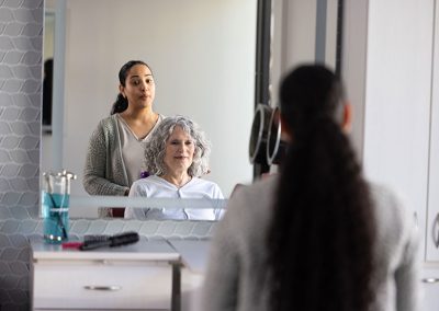 two women in mirror at salon